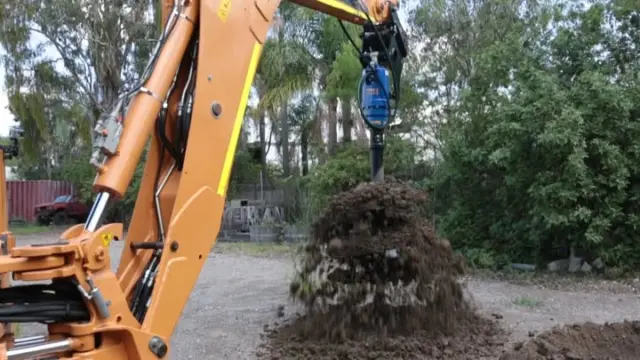 Digging fence post holes by hand is a good way to lose a whole afternoon. 

Our Earth Drill & Auger turns that same job into twenty minutes of work, and the hole comes out straight every time. Runs on skid steers, excavators, and backhoes like this one and swaps bit sizes depending on what you're boring. 

If your crew is still setting posts with a manual digger, it's worth a phone call.